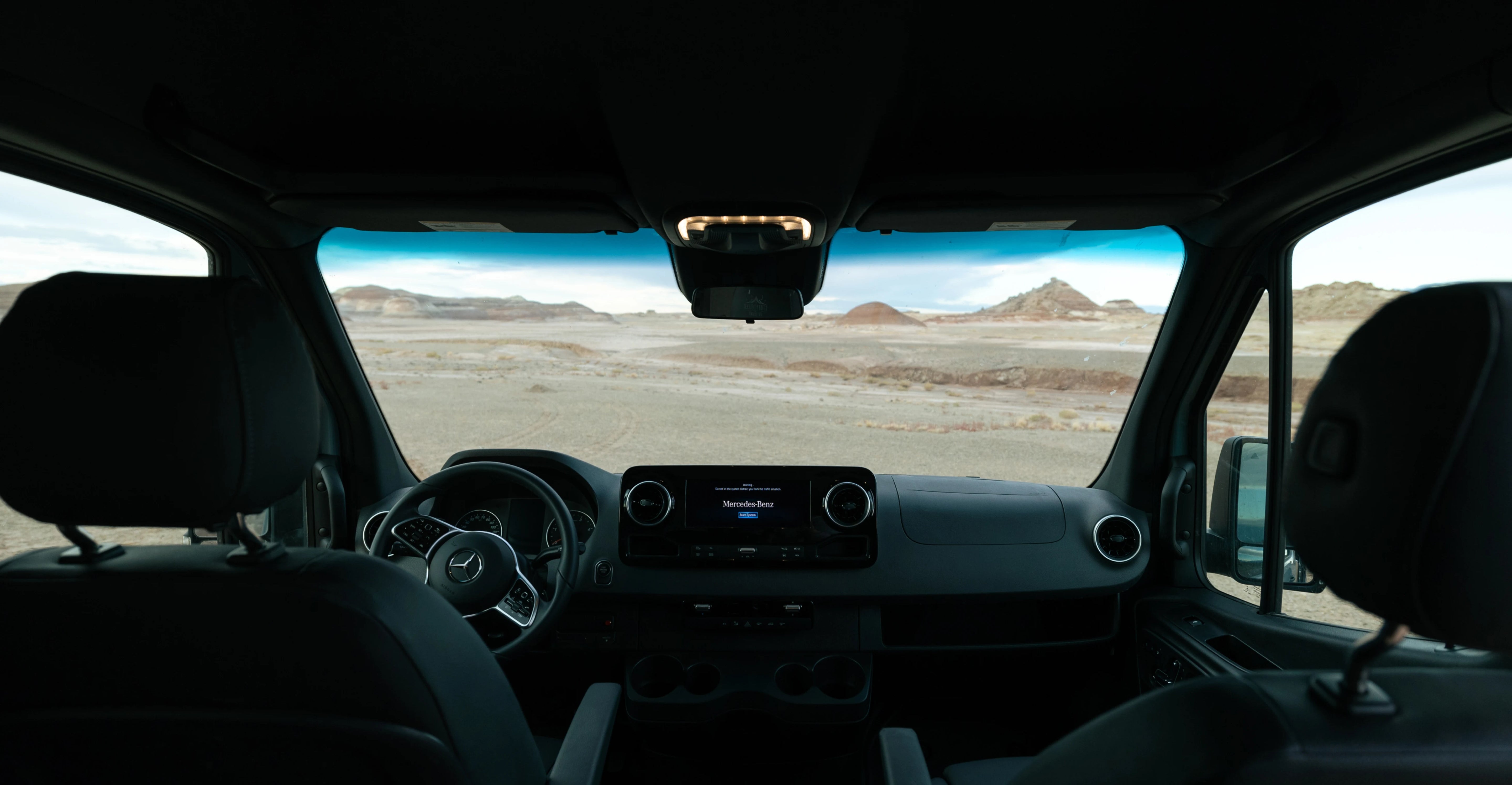 Modern Sprinter Van camper van interior with desert view, perfect for vanlife and overlanding.
