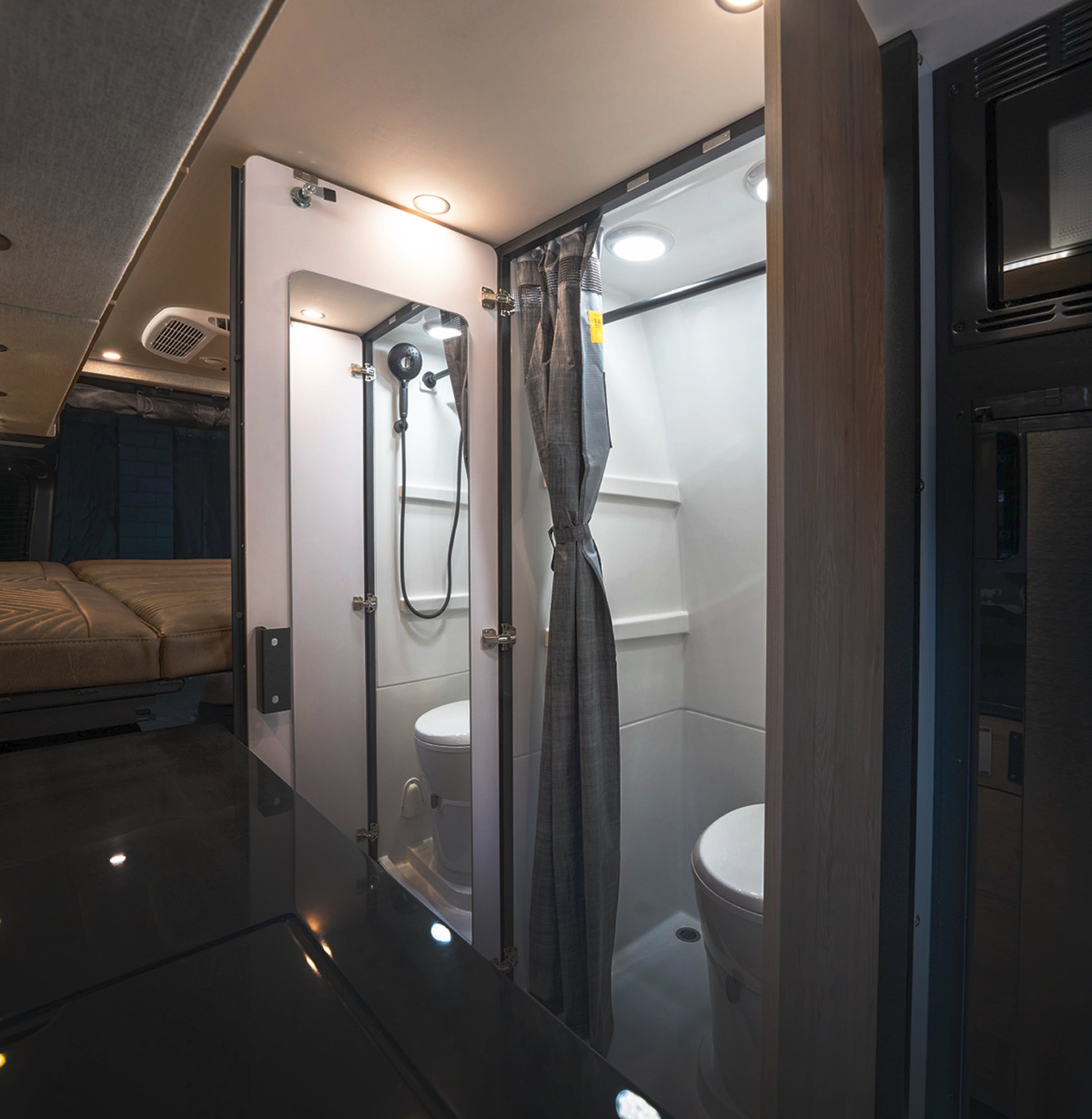 Compact wet bath with shower and toilet inside luxury camper van for overlanding or vanlife