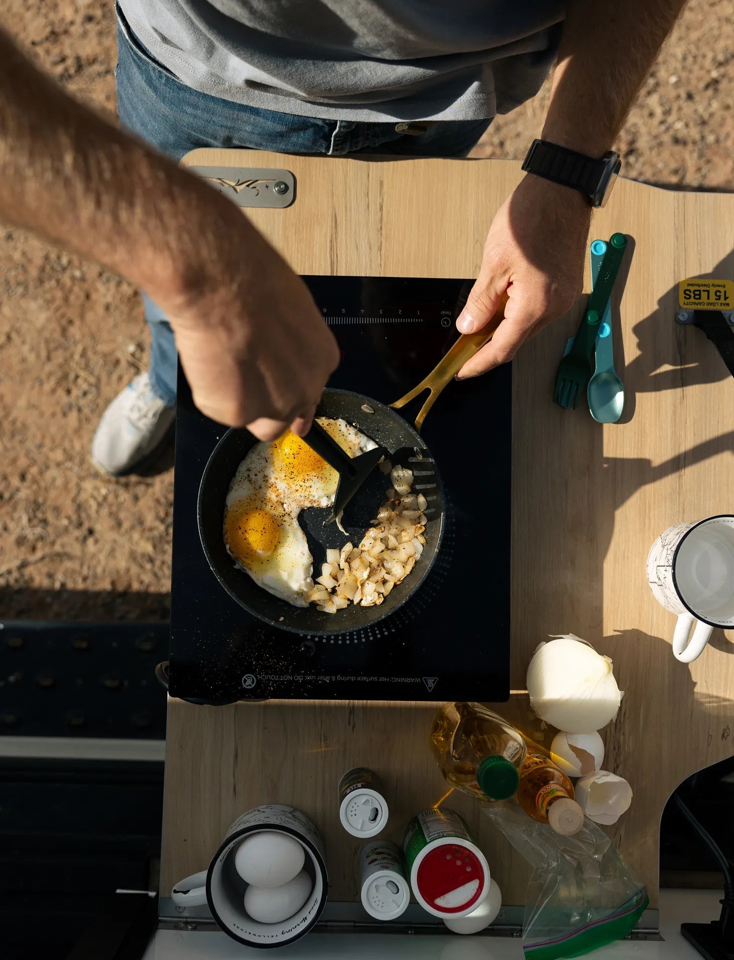 Outdoor cooking eggs and potatoes on induction stove in camper van, ideal for vanlife adventure travel