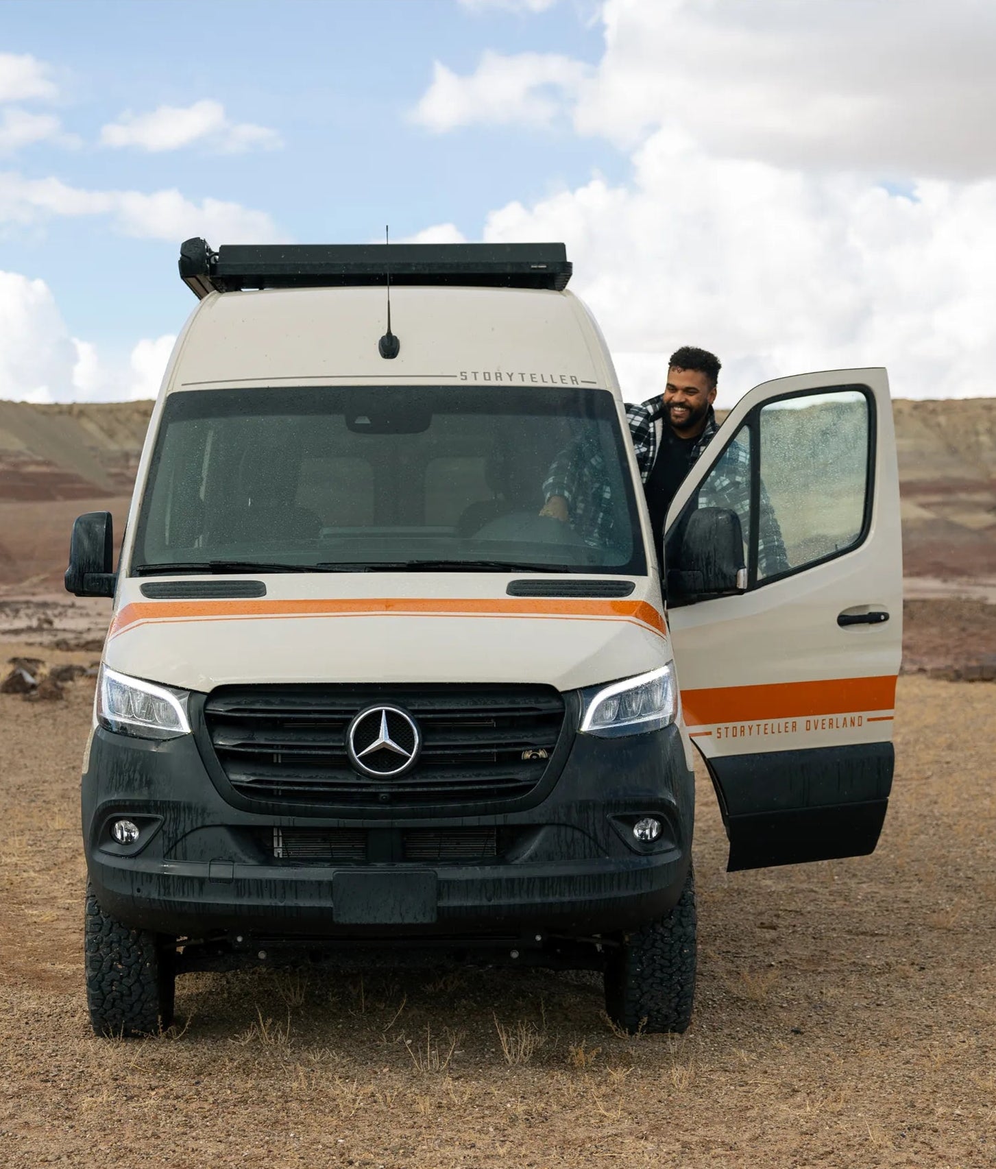 Front view of Classic MODE 4x4 camper van, Sprinter overland adventure van in rugged outdoors