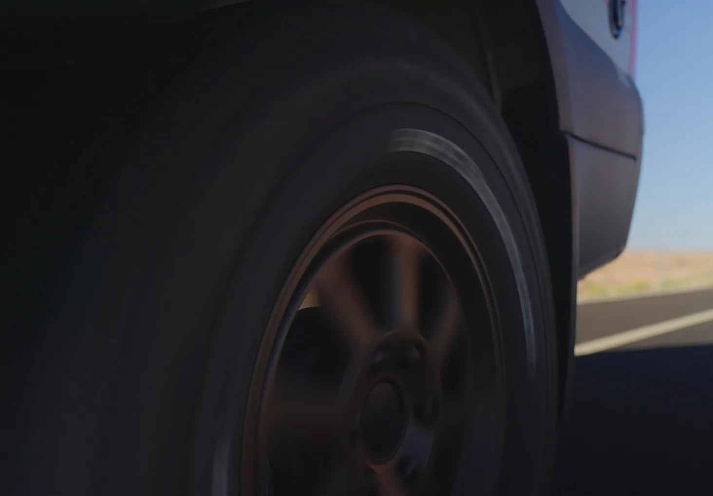Close-up of spinning tire on an adventure van or Class B RV, ideal for overlanding travel