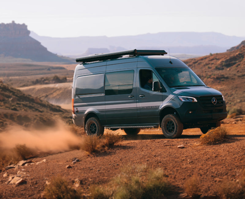 Sprinter 4x4 camper van driving offroad in desert, overland adventure van for van life travel