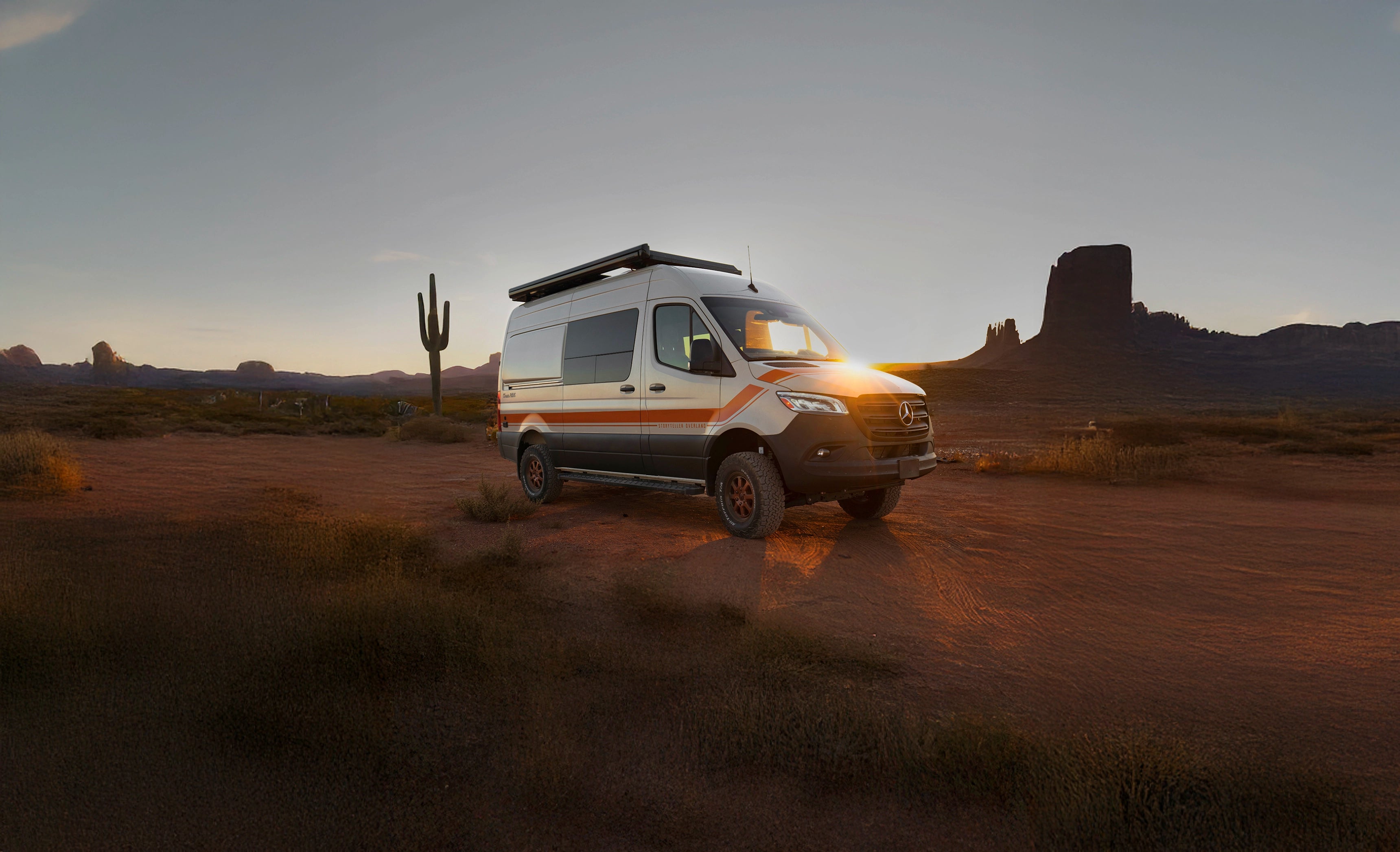 Sprinter 4x4 camper van parked in desert at sunset, ideal for overlanding and vanlife adventures