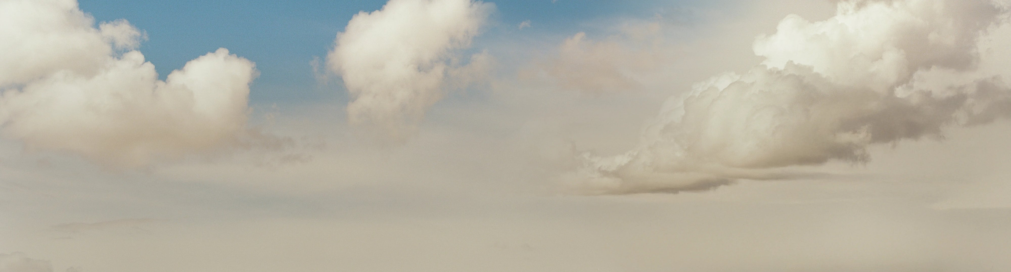 Open sky with fluffy clouds, ideal backdrop for adventure van, campervan, vanlife, overlanding themes
