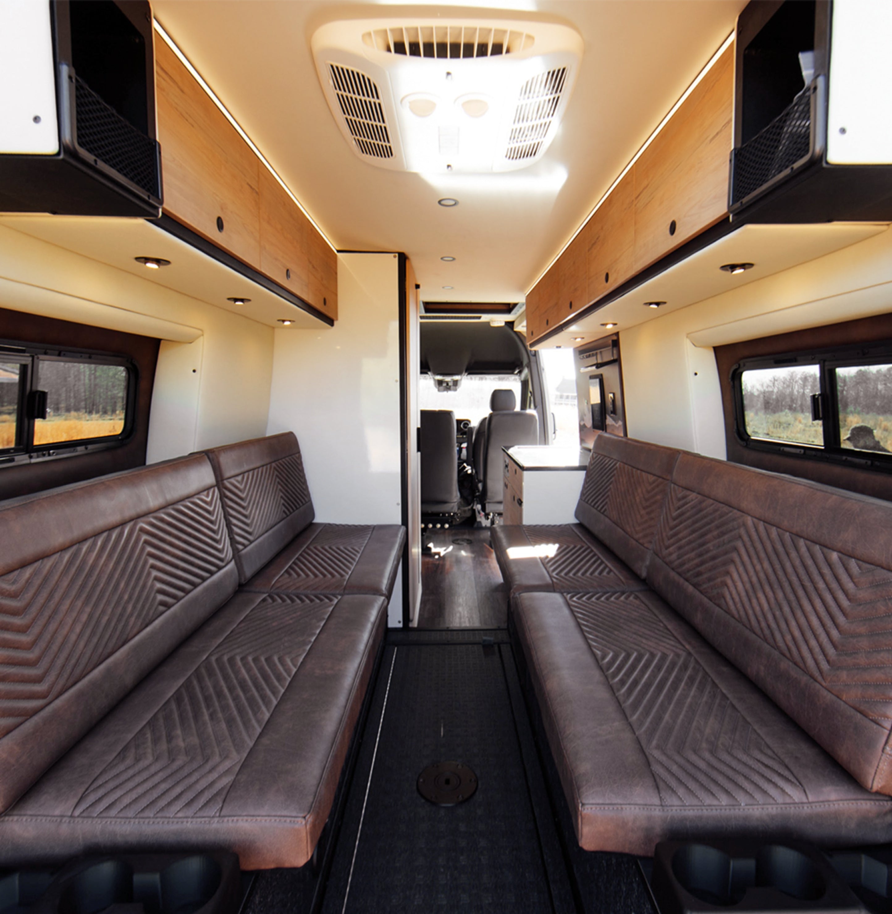 Modern camper van interior with leather lounge seating, overland conversion, ideal for vanlife
