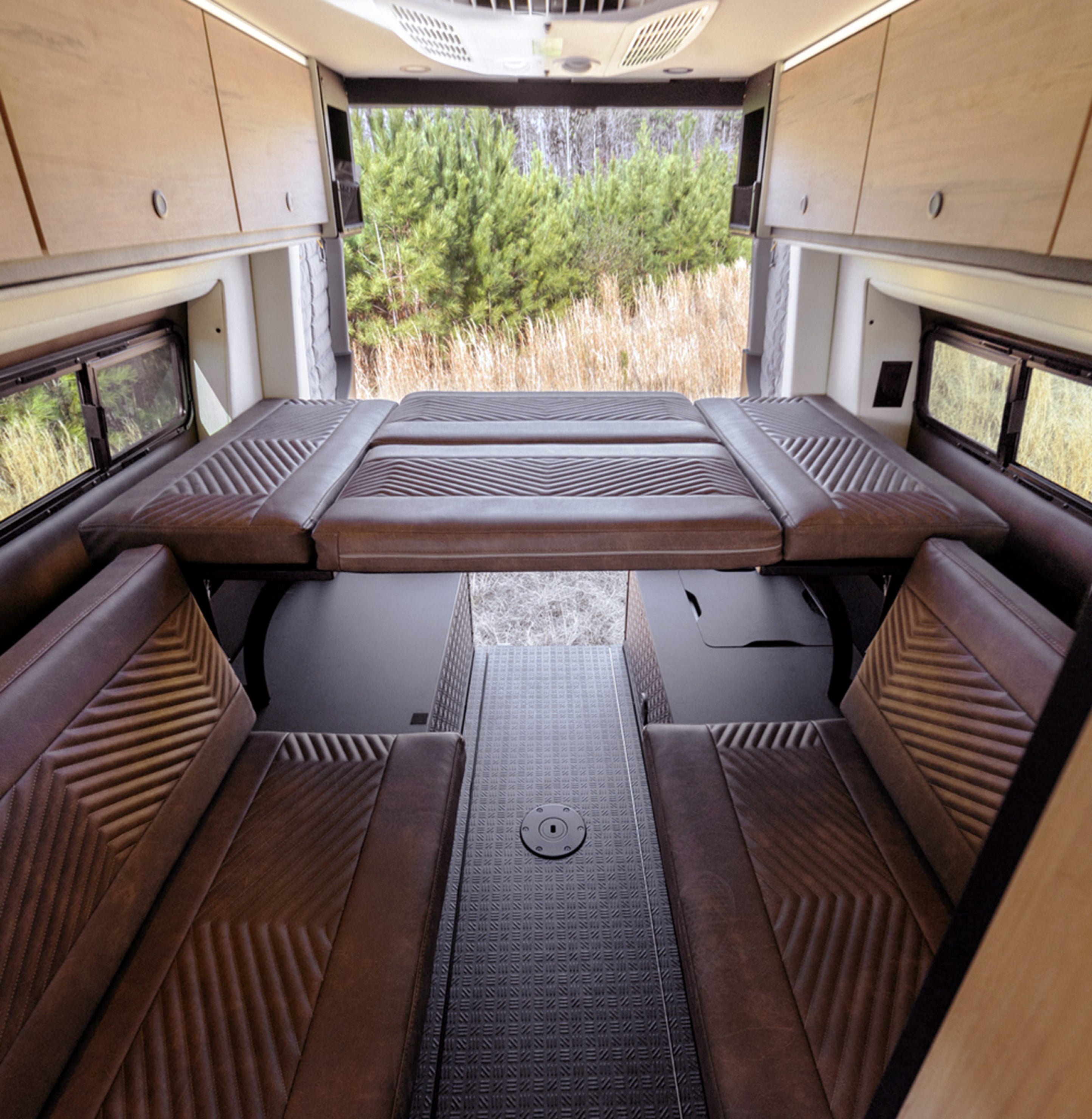 Custom camper van interior with fold-out bed, ideal for adventure van life and road trips