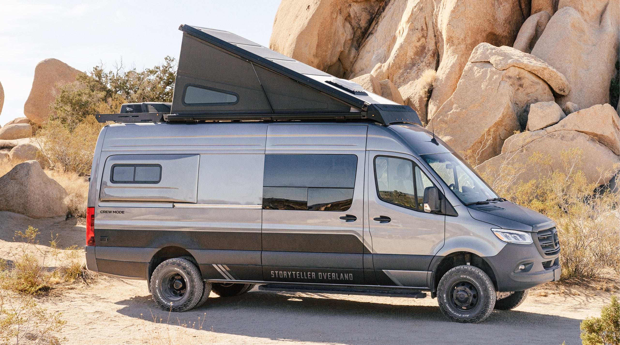 Adventure Van with pop-top roof parked in desert, offroad Sprinter 4x4 campervan for vanlife