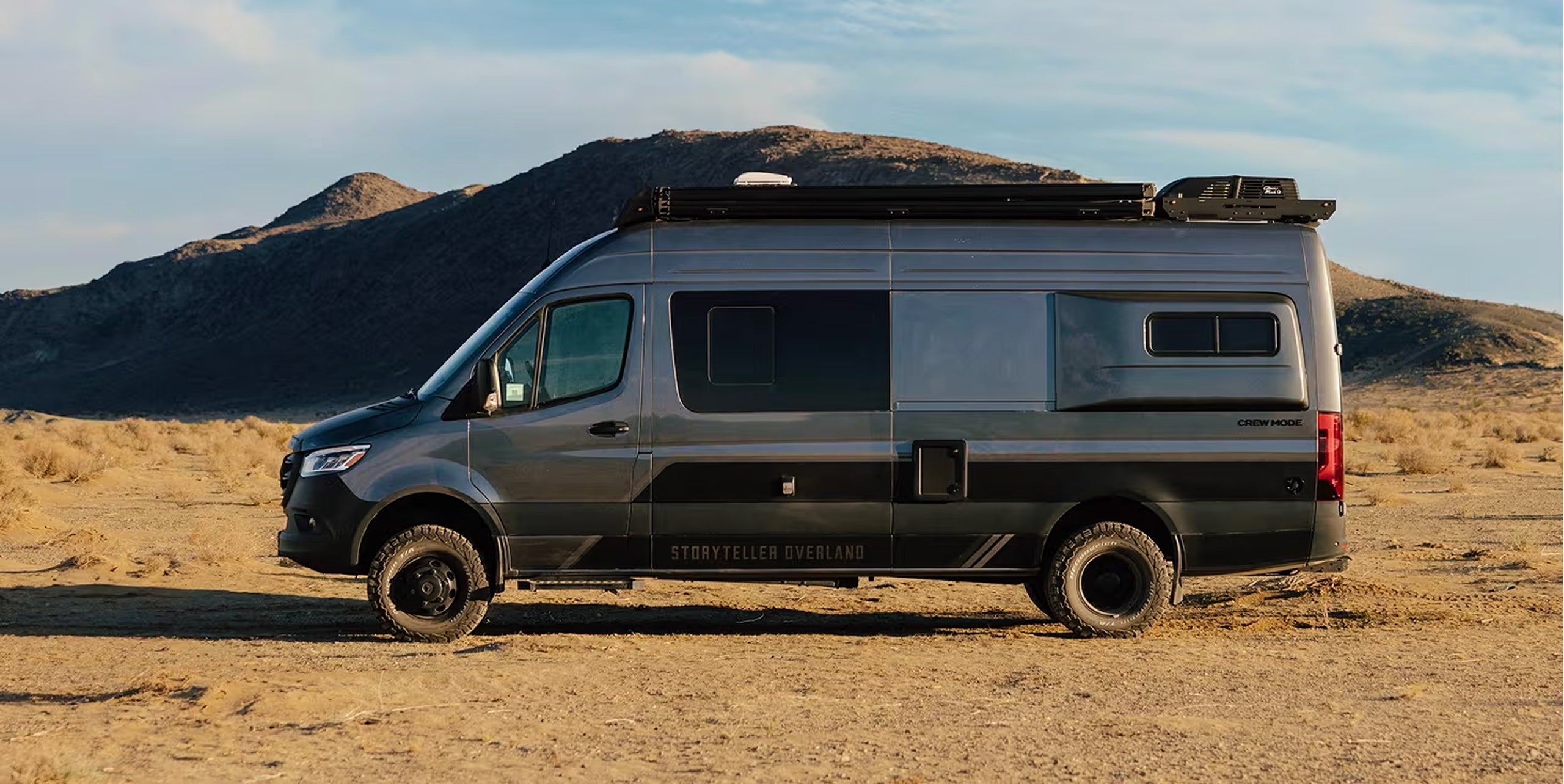 Adventure Van, Class B RV with offroad tires parked in desert, modern camper van for Vanlife