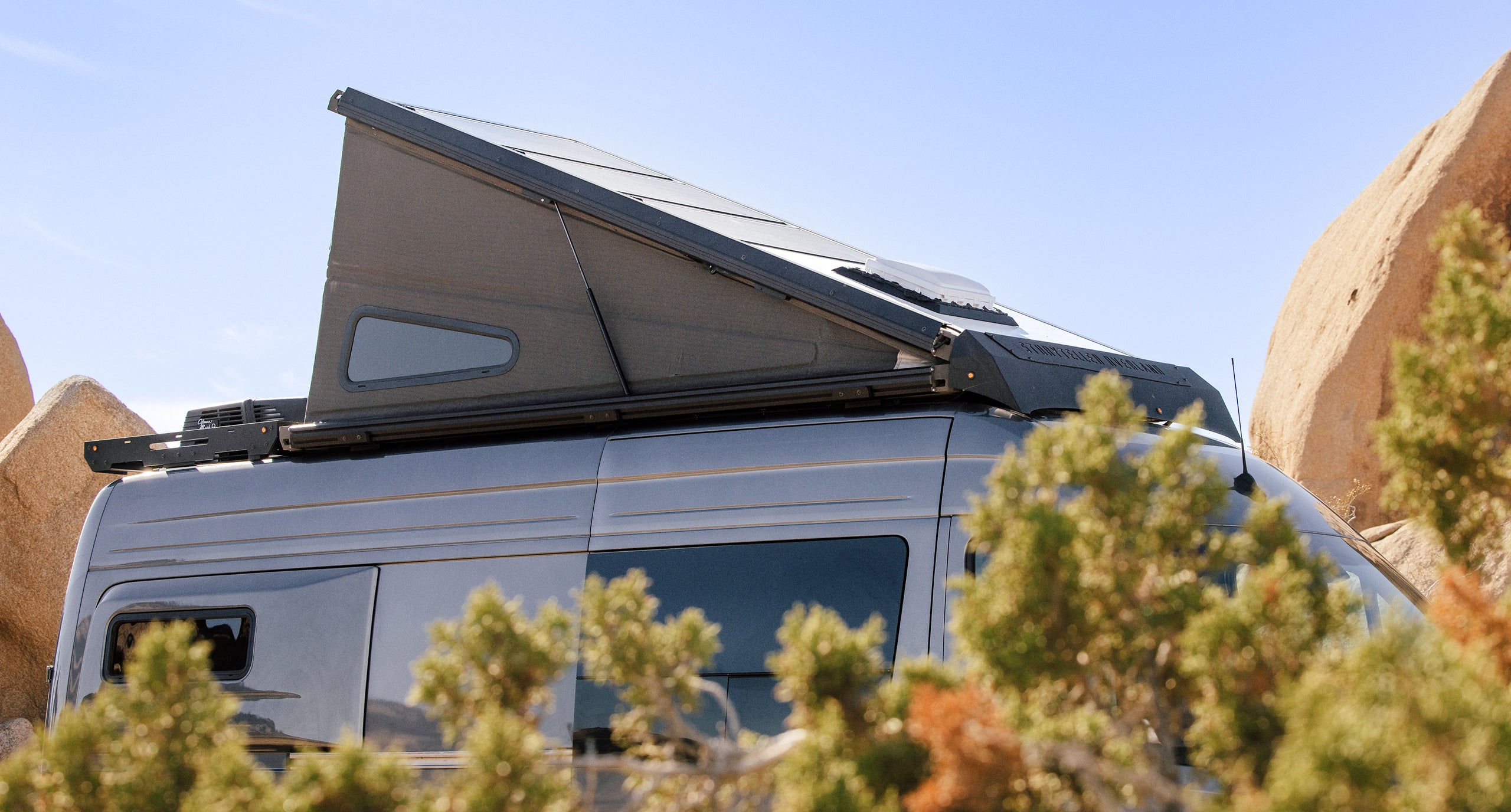 Pop-top Adventure Van with roof tent, Sprinter 4x4 camper van in desert overlanding setting