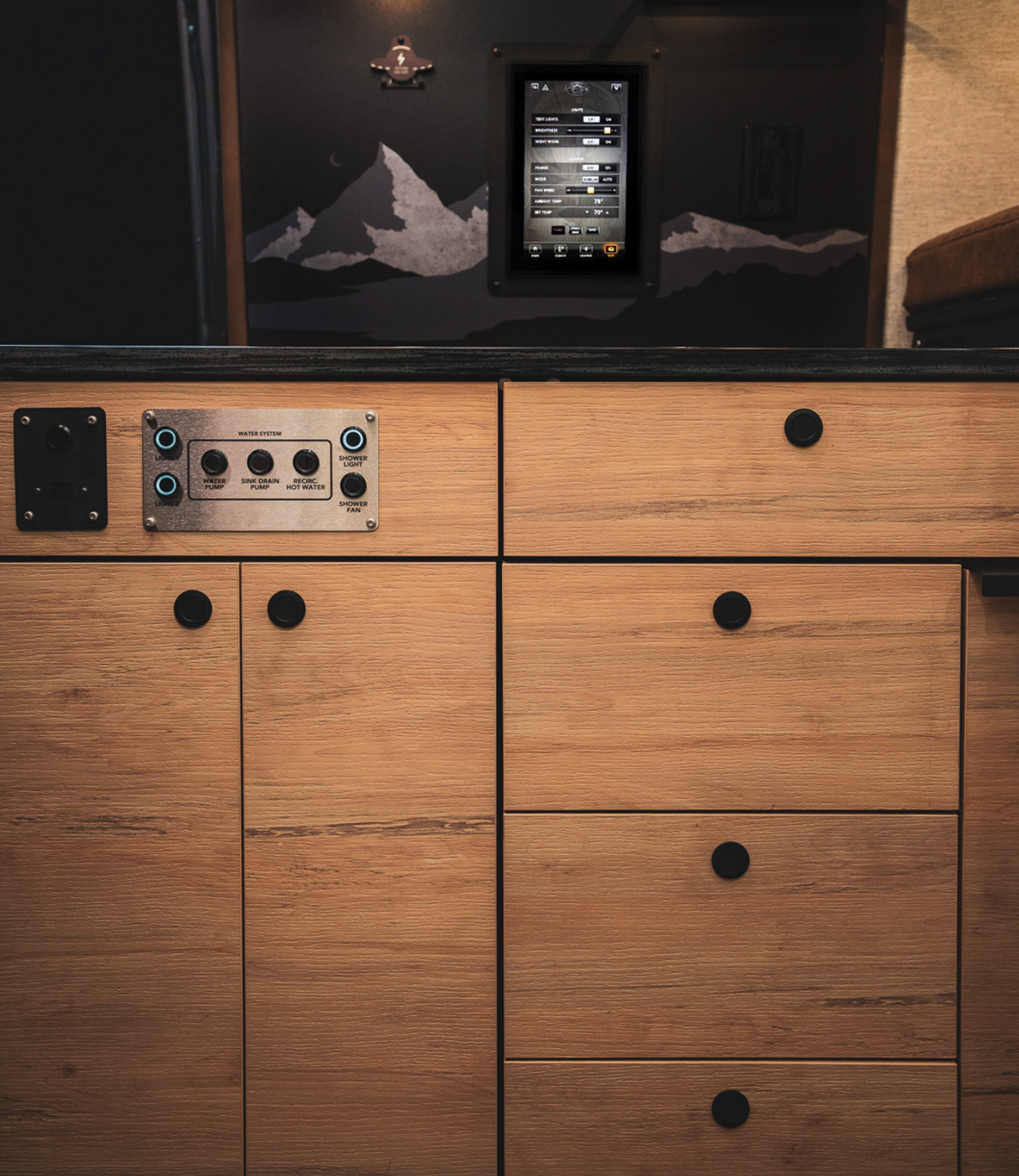 Camper van interior control panel and touch screen, modern cabinetry, overland adventure van.