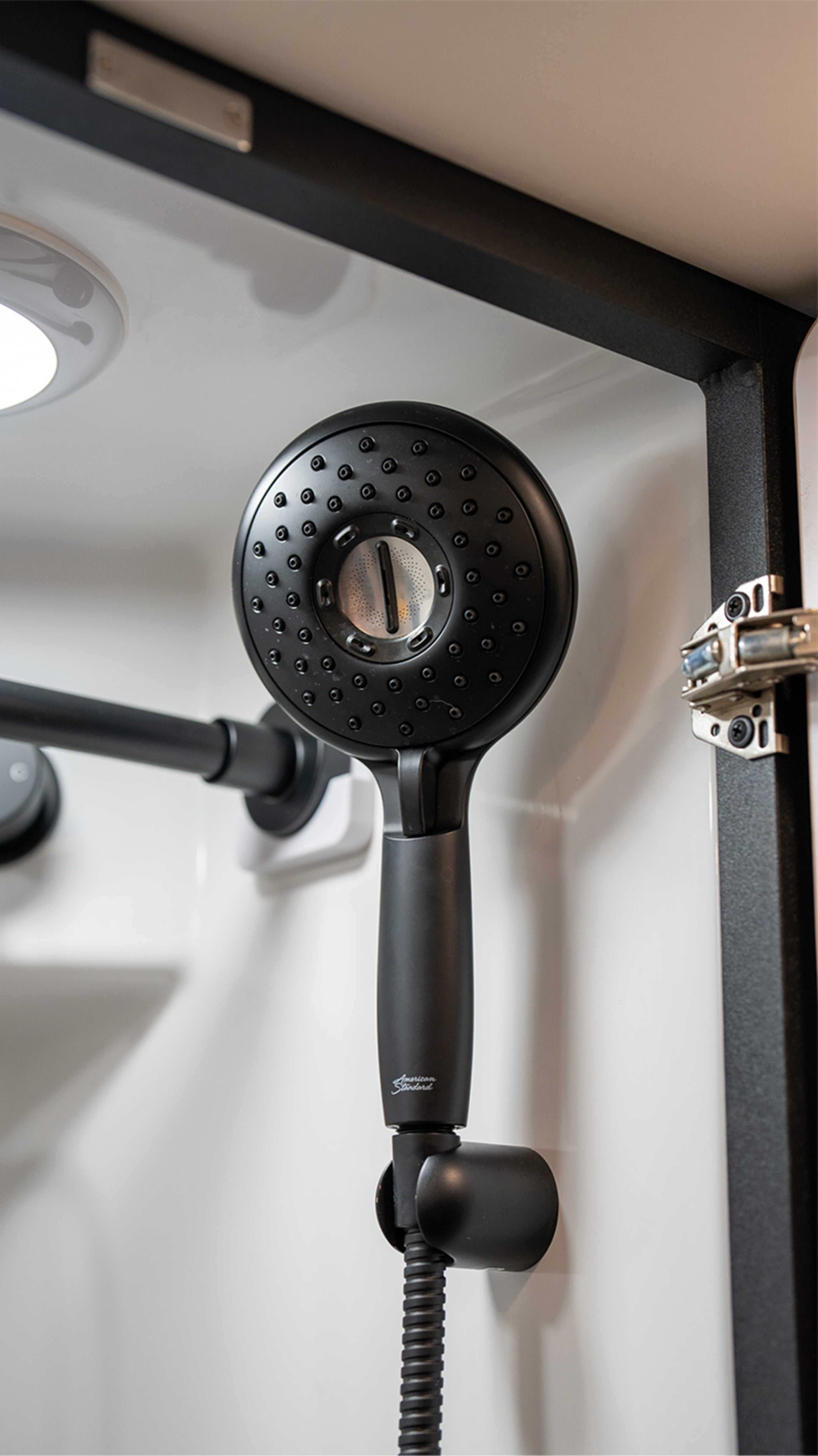 Modern shower head in camper van bathroom, ideal for Class B RV, vanlife, overland travel