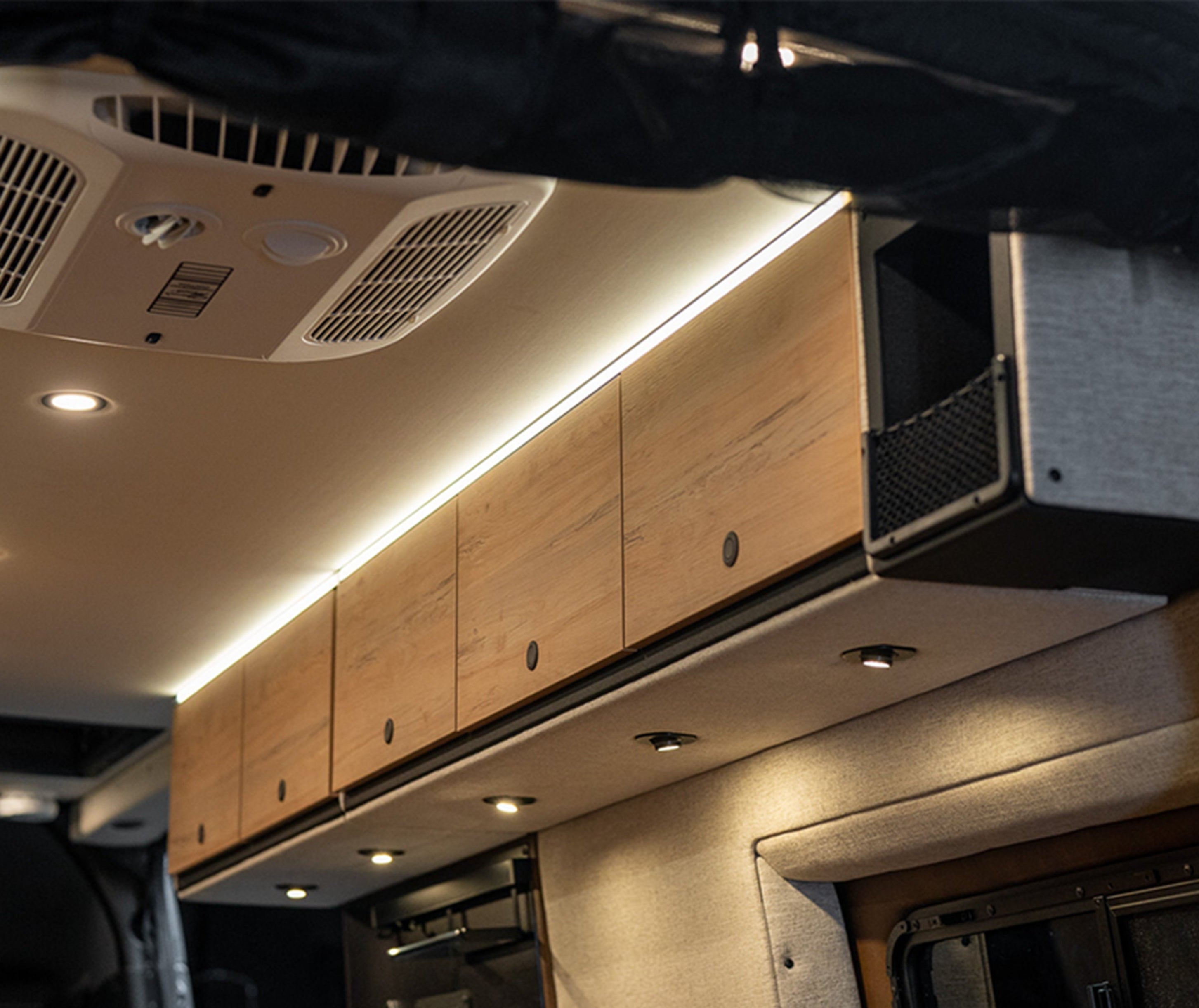 Overhead storage cabinets inside luxury adventure van, campervan, or Class B RV interior