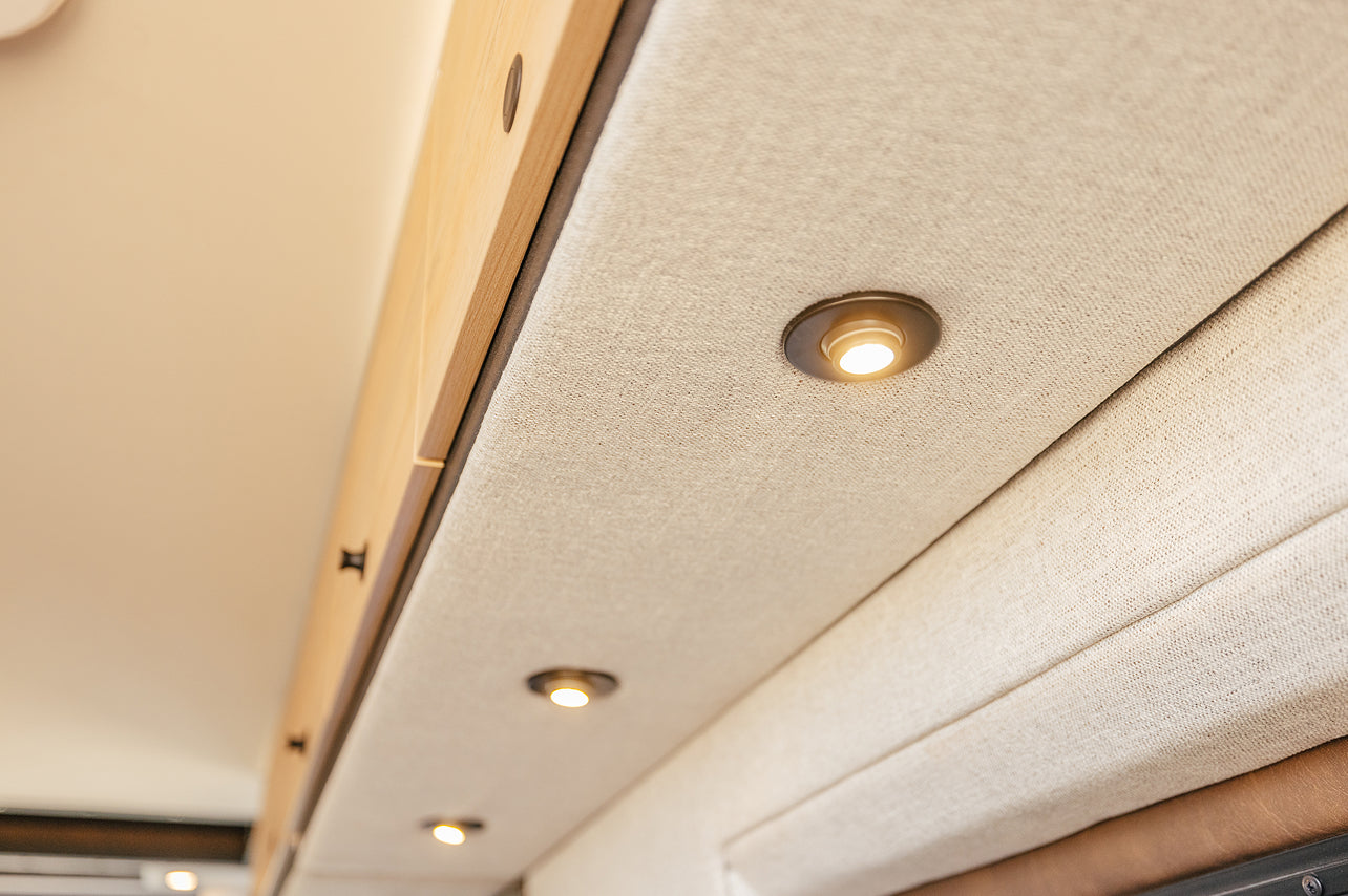 LED lights on fabric ceiling in luxury camper van interior, modern adventure van design