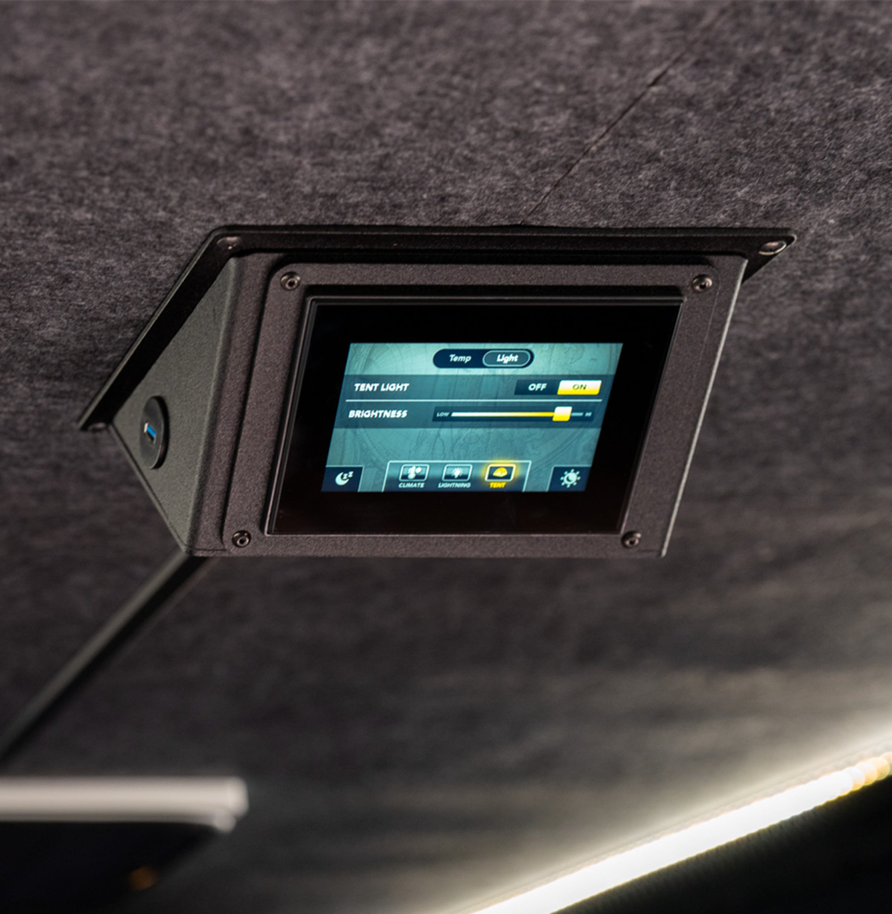 Touchscreen control panel in camper van interior for lighting and climate in adventure van