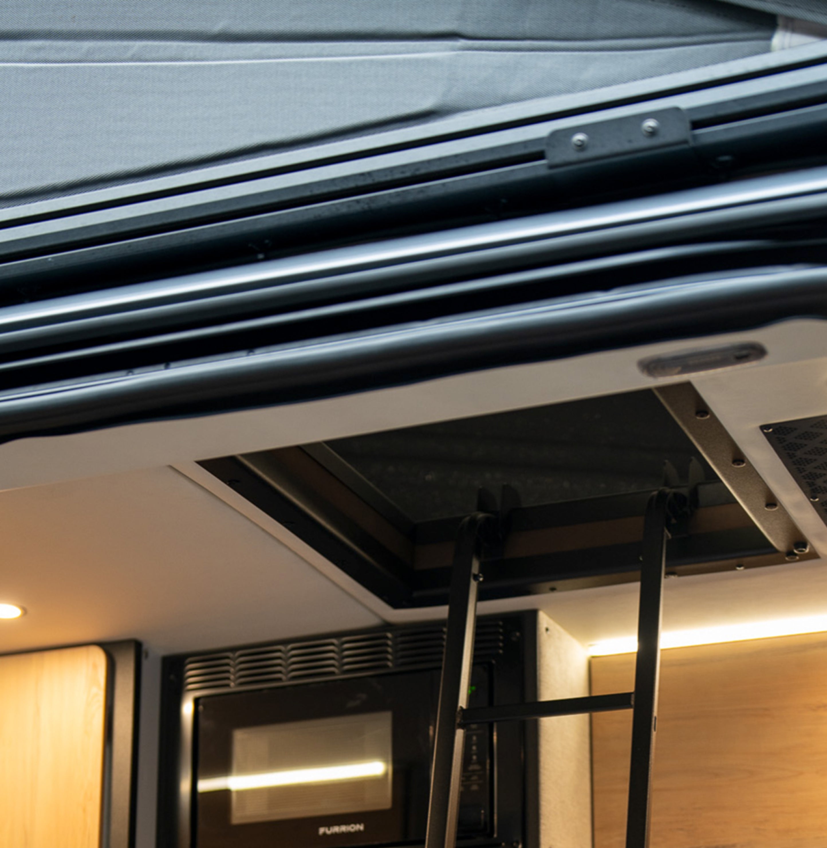 Interior pop-top roof ladder and kitchenette in Sprinter van camper, vanlife ready
