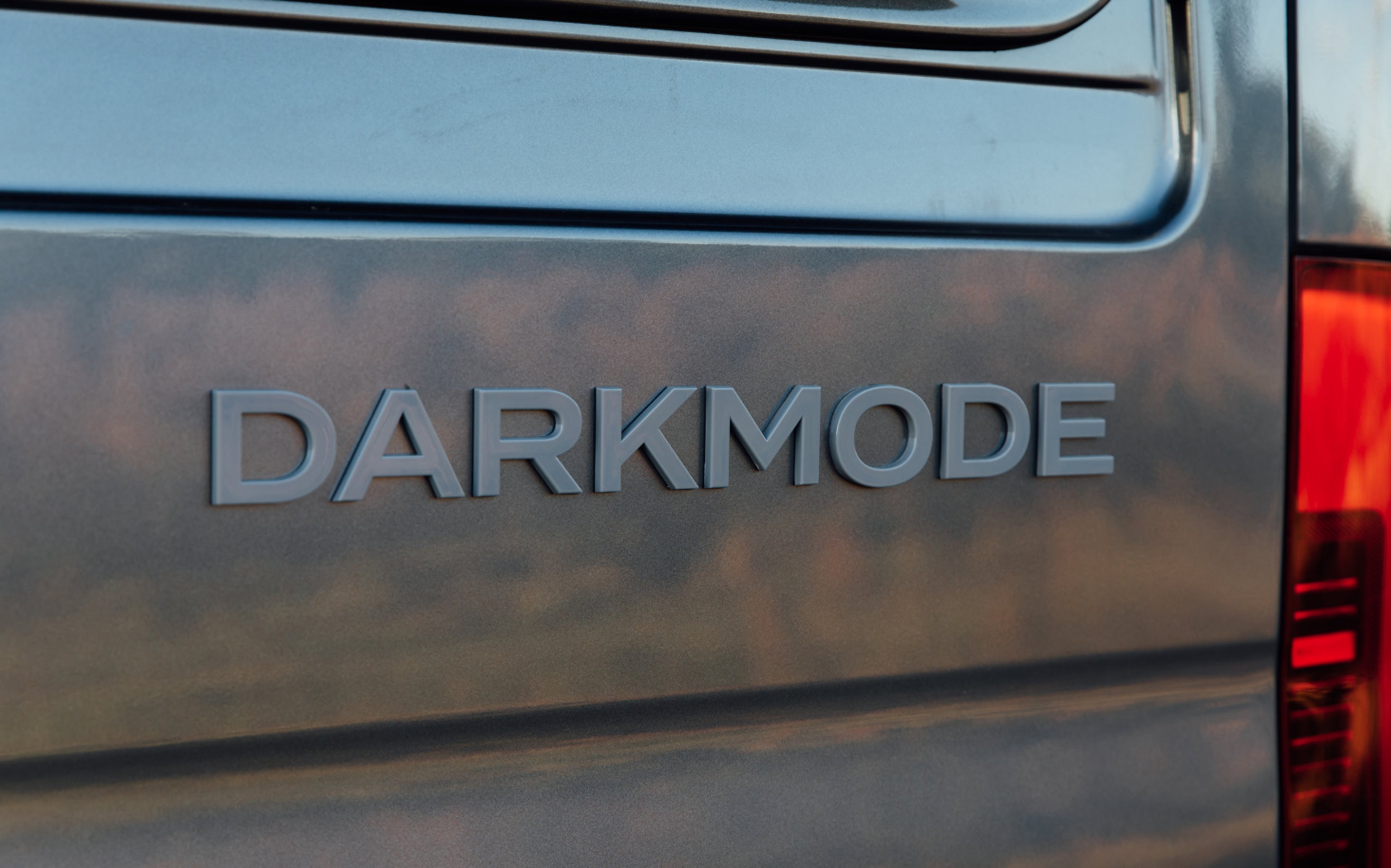 DARKMODE badge on grey adventure van exterior, Camper Van, Overland, Vanlife, Expedition Vehicle