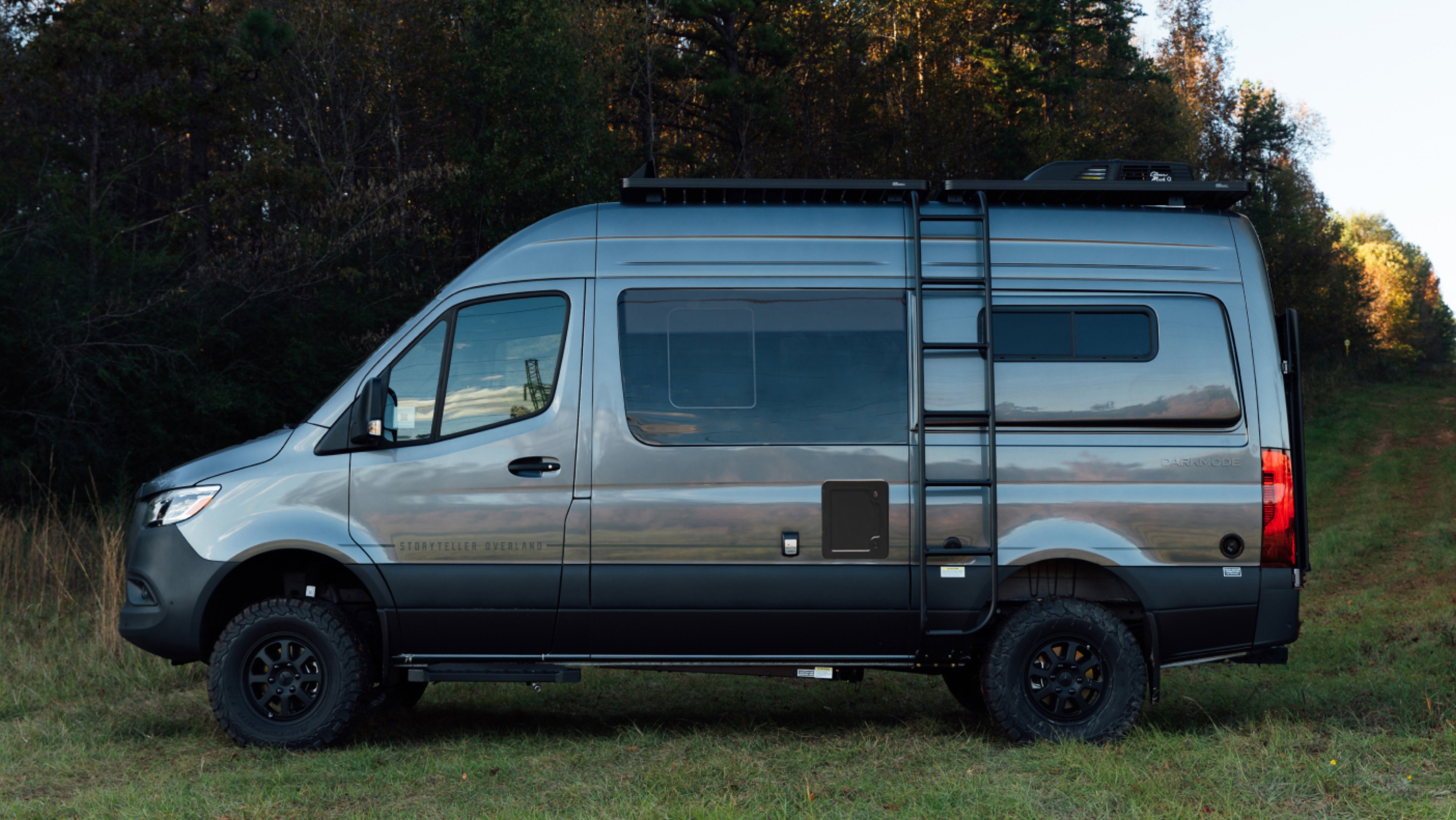 Adventure Van Sprinter 4x4 camper van with ladder, offroad tires, overlanding setup in nature