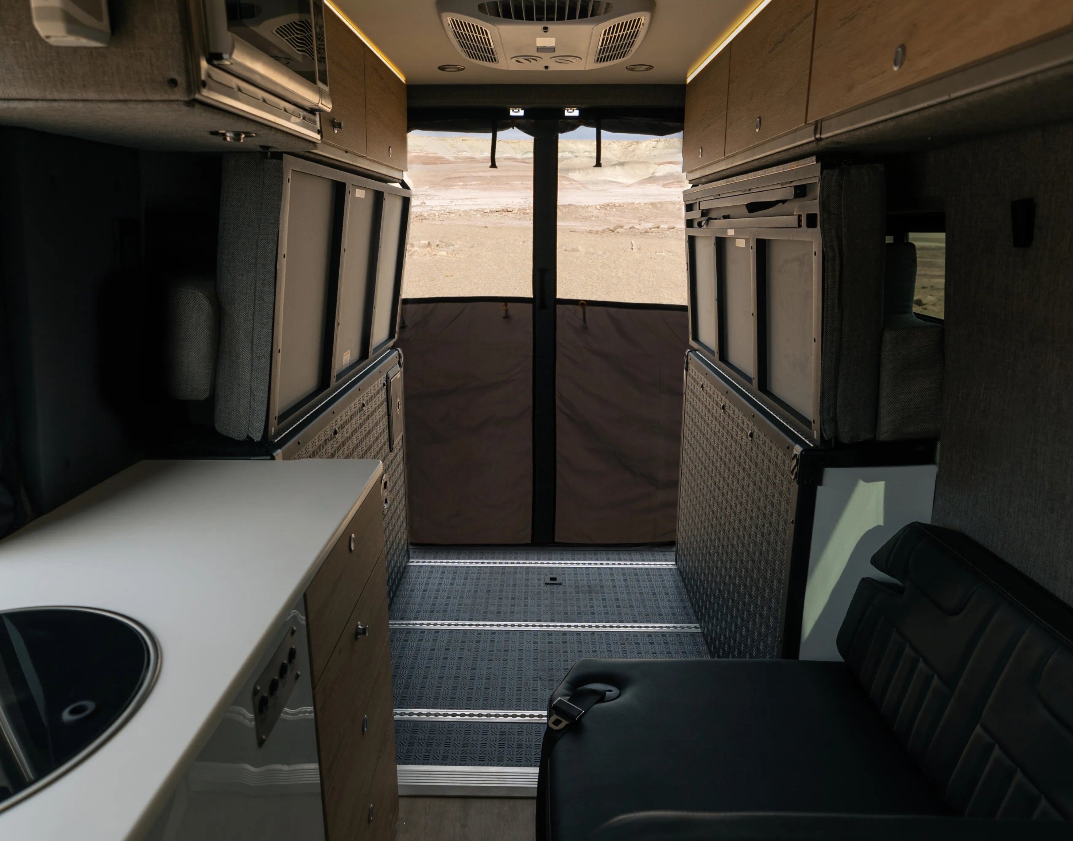 Modern interior of adventure van campervan with kitchen, seating, and storage for vanlife travel