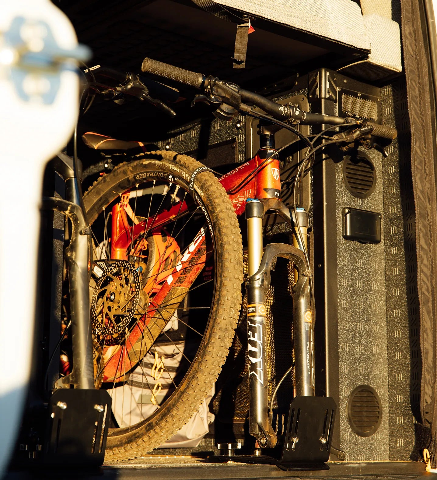 Mountain bike secured inside camper van garage, perfect for vanlife adventure travel and overlanding.