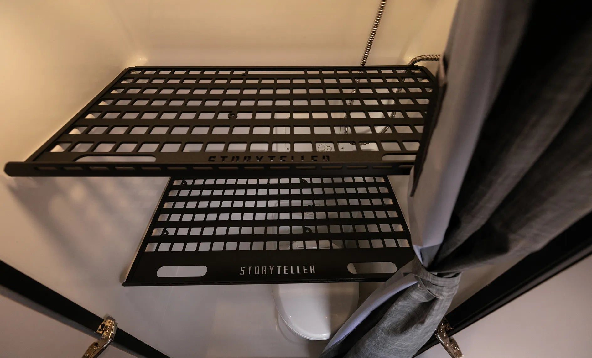 Metal bathroom shelf in camper van interior, ideal for adventure van, vanlife, MODE 4x4 or overland vehicle storage.