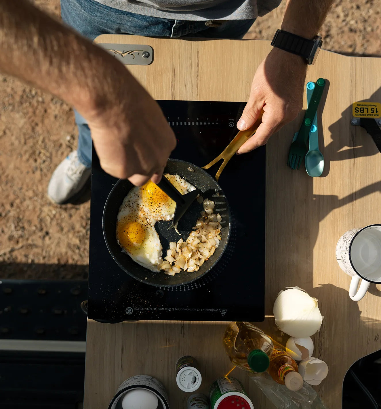 Cooking eggs and potatoes in a camper van kitchen, perfect for vanlife or overlanding trips.