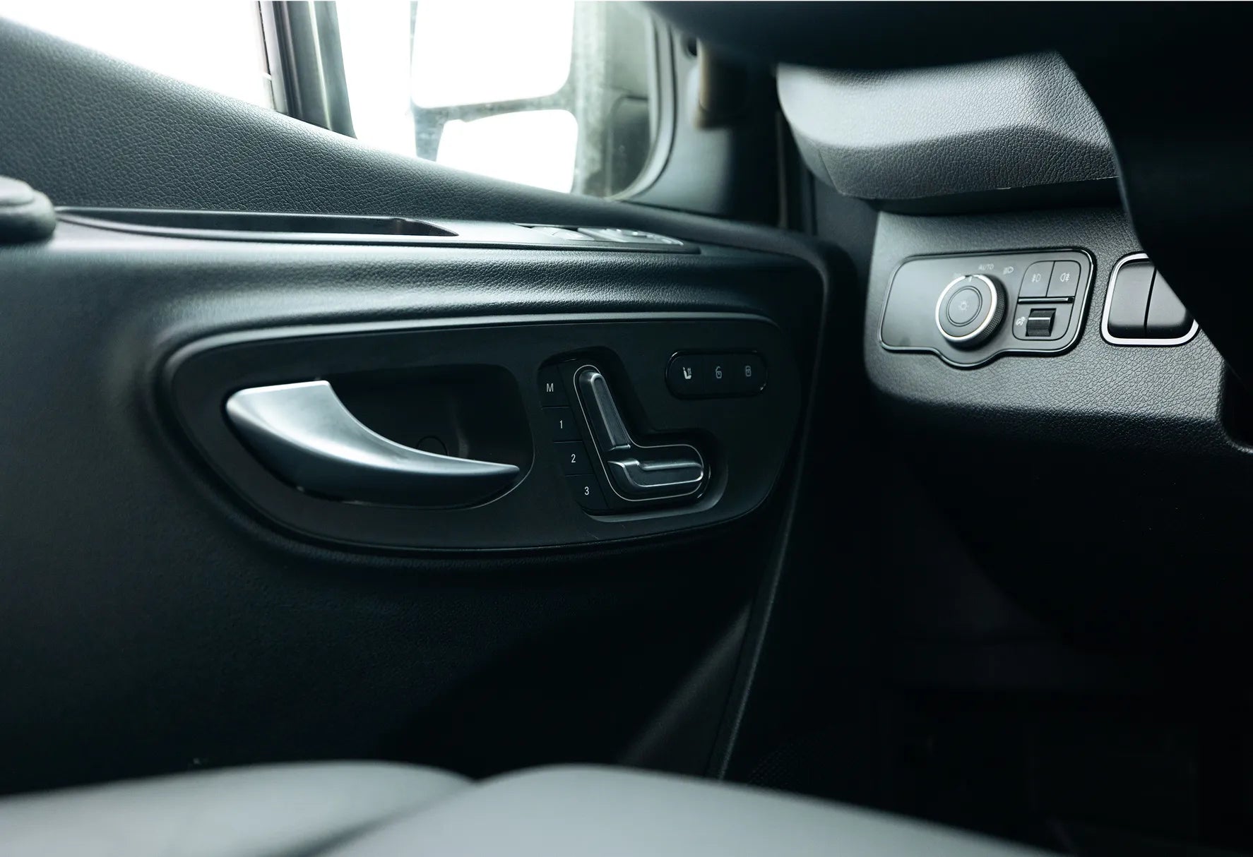 Luxury interior door with seat controls in adventure camper van, Class B RV or Sprinter Van