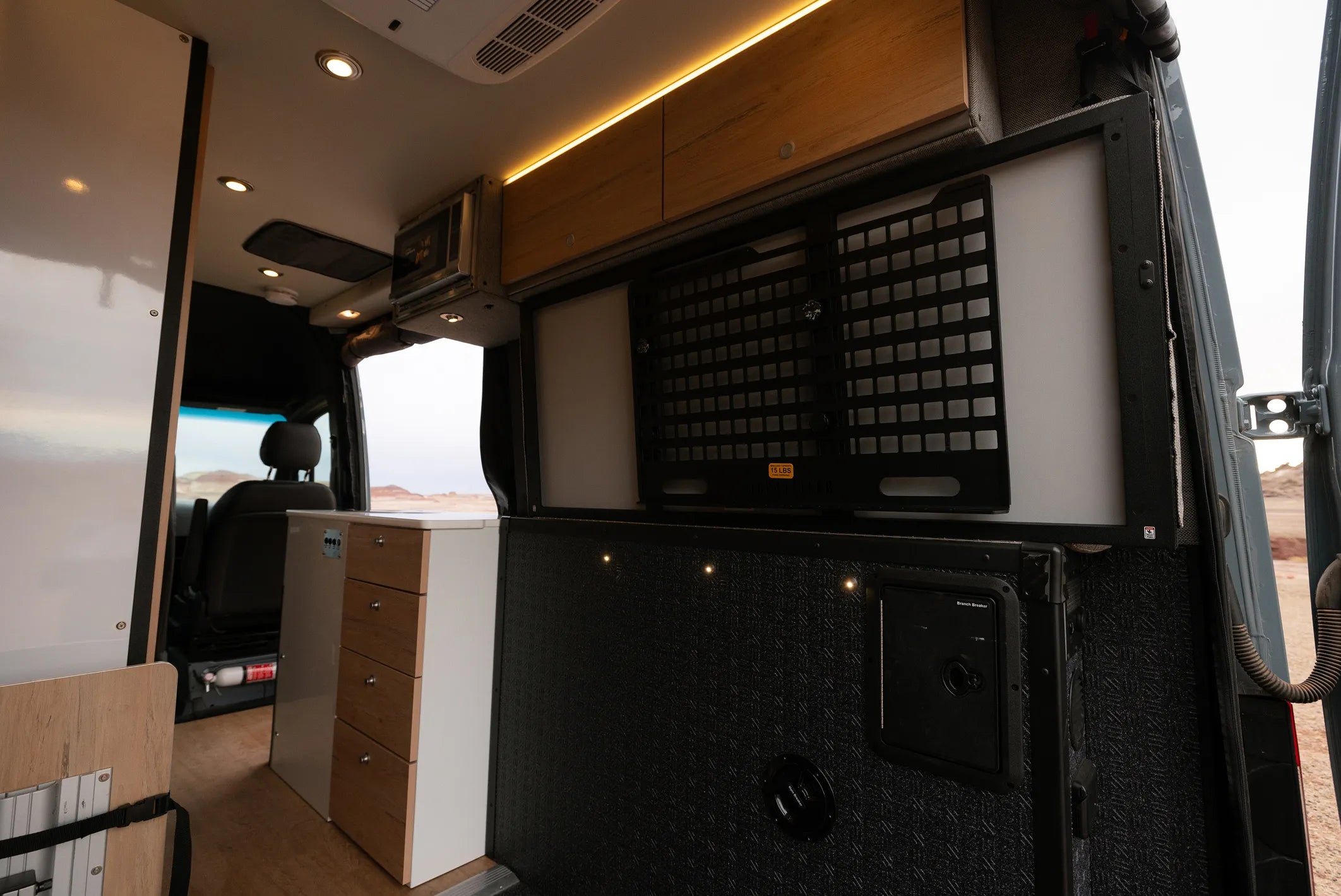 Modern campervan interior with storage cabinets, ideal for overland adventure travel and vanlife.