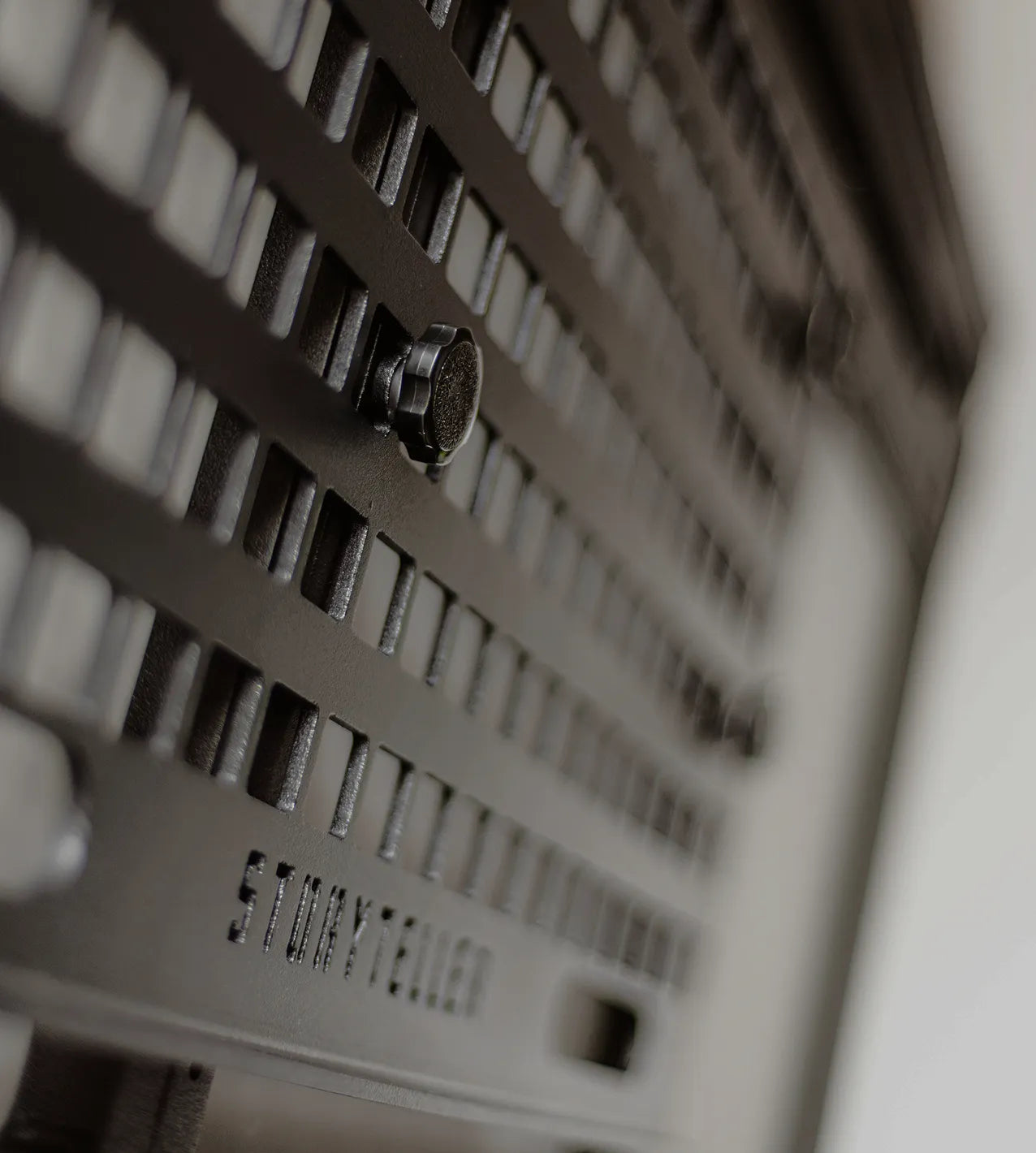 Close-up of modular interior storage panel in an adventure van or campervan, with mounting knob.