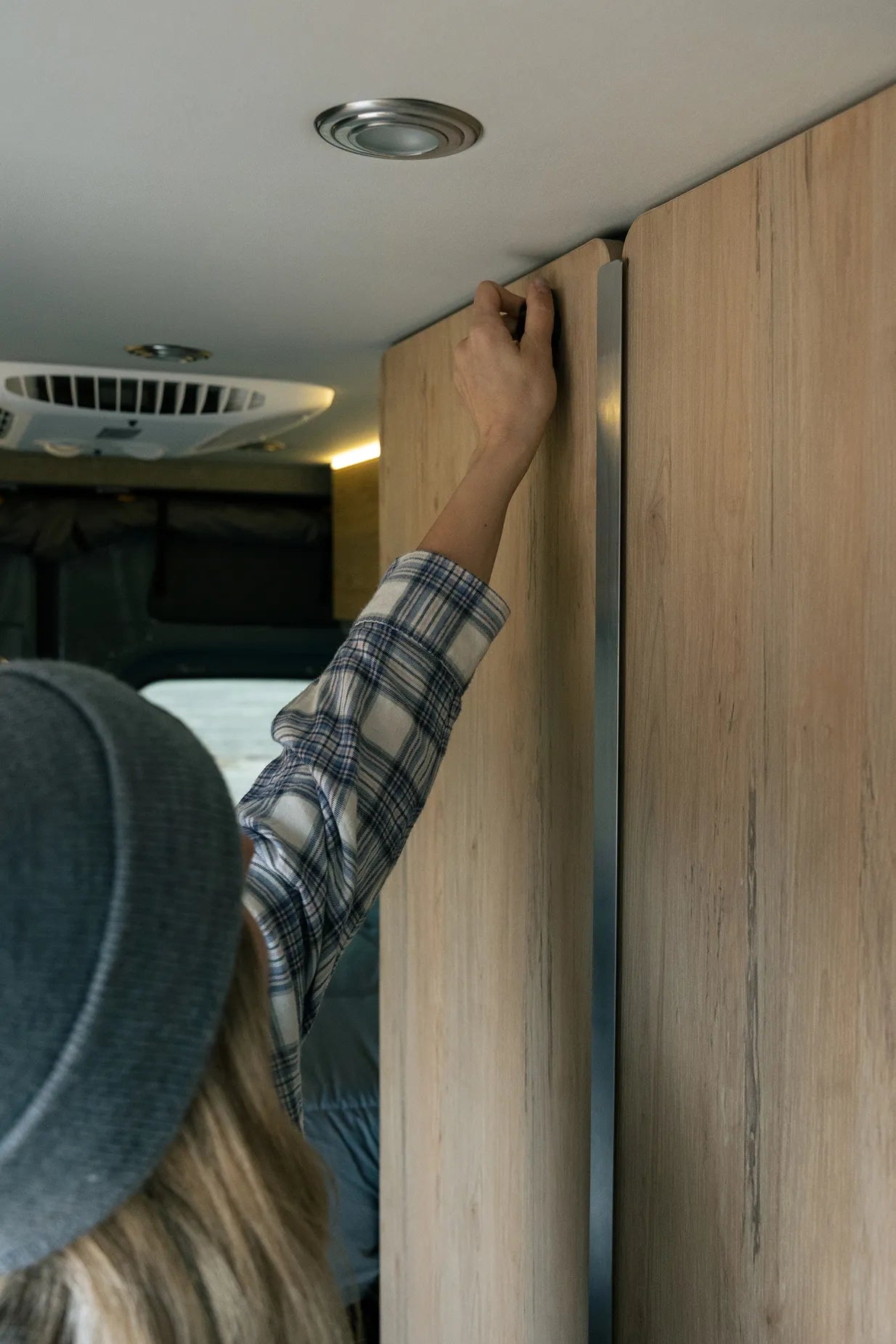 Camper van interior with overhead storage, ideal for vanlife and adventure travel.