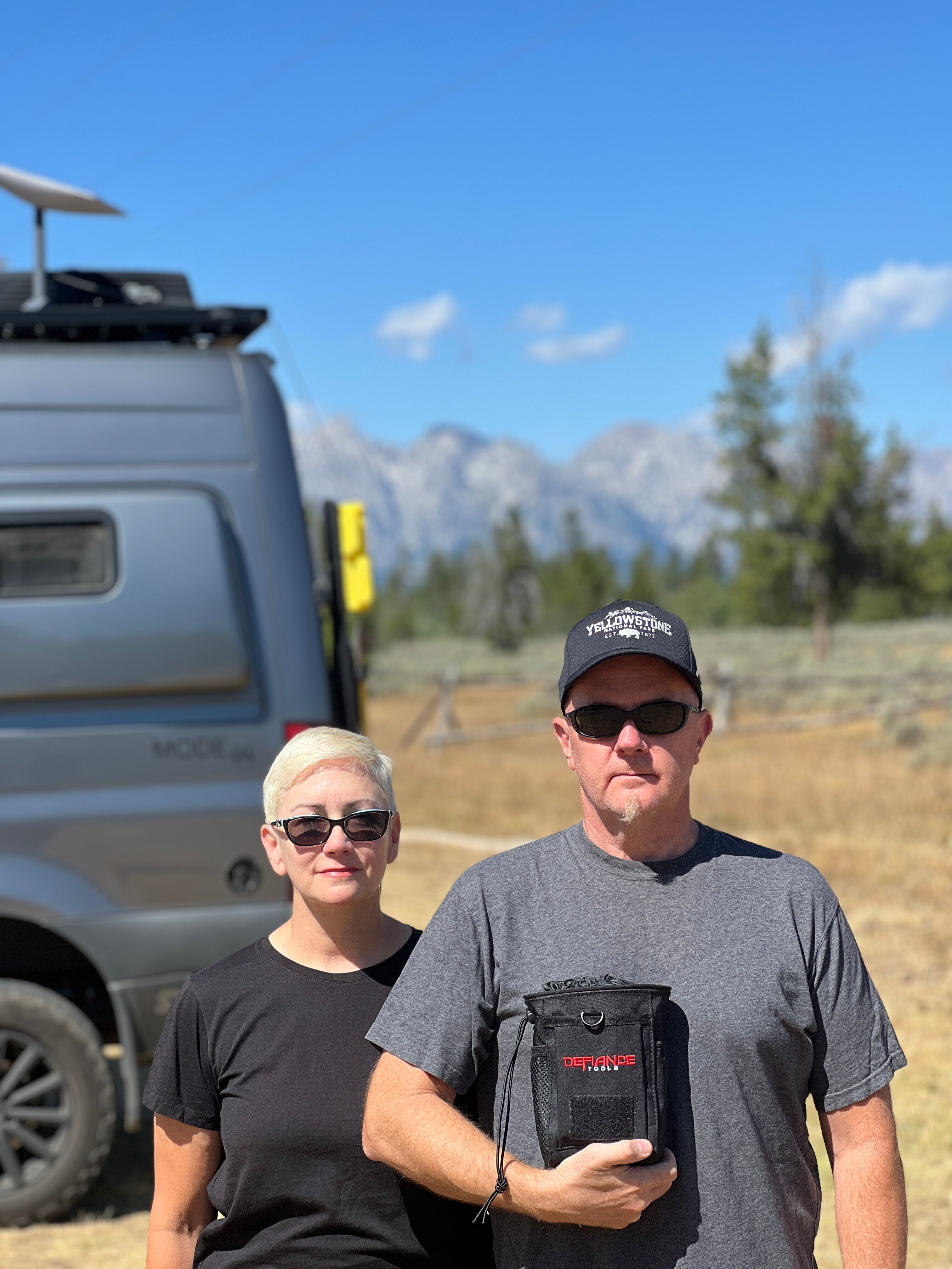 Couple with offroad camper van, MODEx4 adventure rig, enjoying vanlife and overlanding outdoors