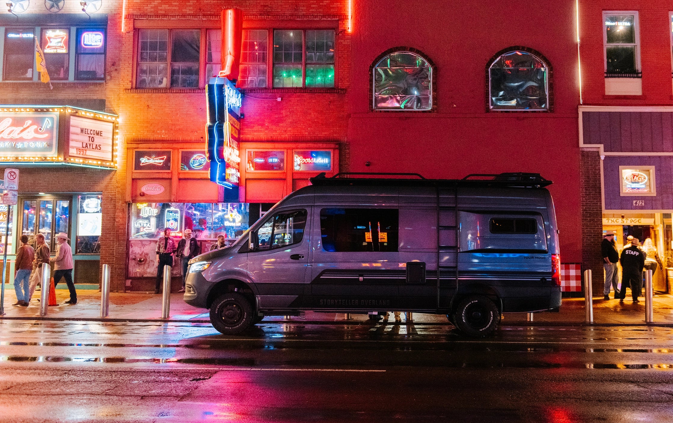 Sprinter 4x4 camper van parked on city street at night, ideal for vanlife and adventure travel