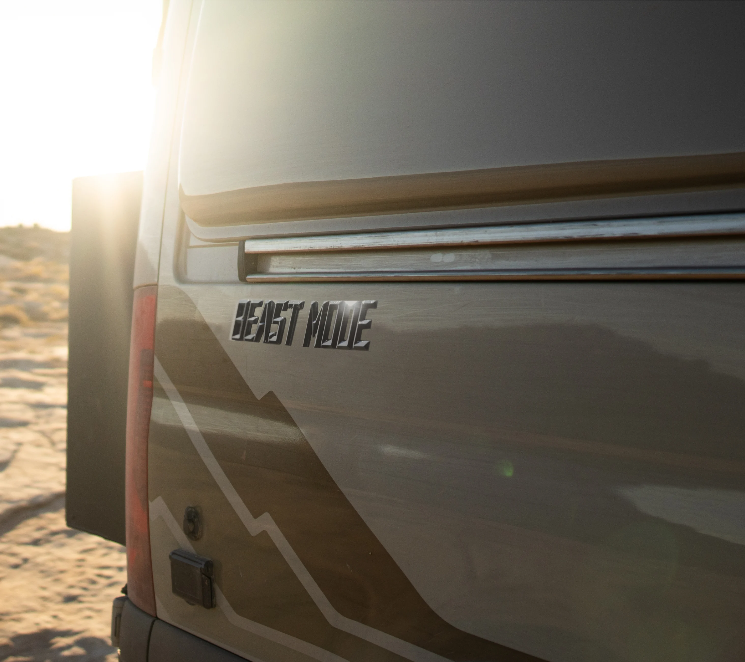 Beast MODE camper van rear exterior logo, offroad adventure van on desert terrain