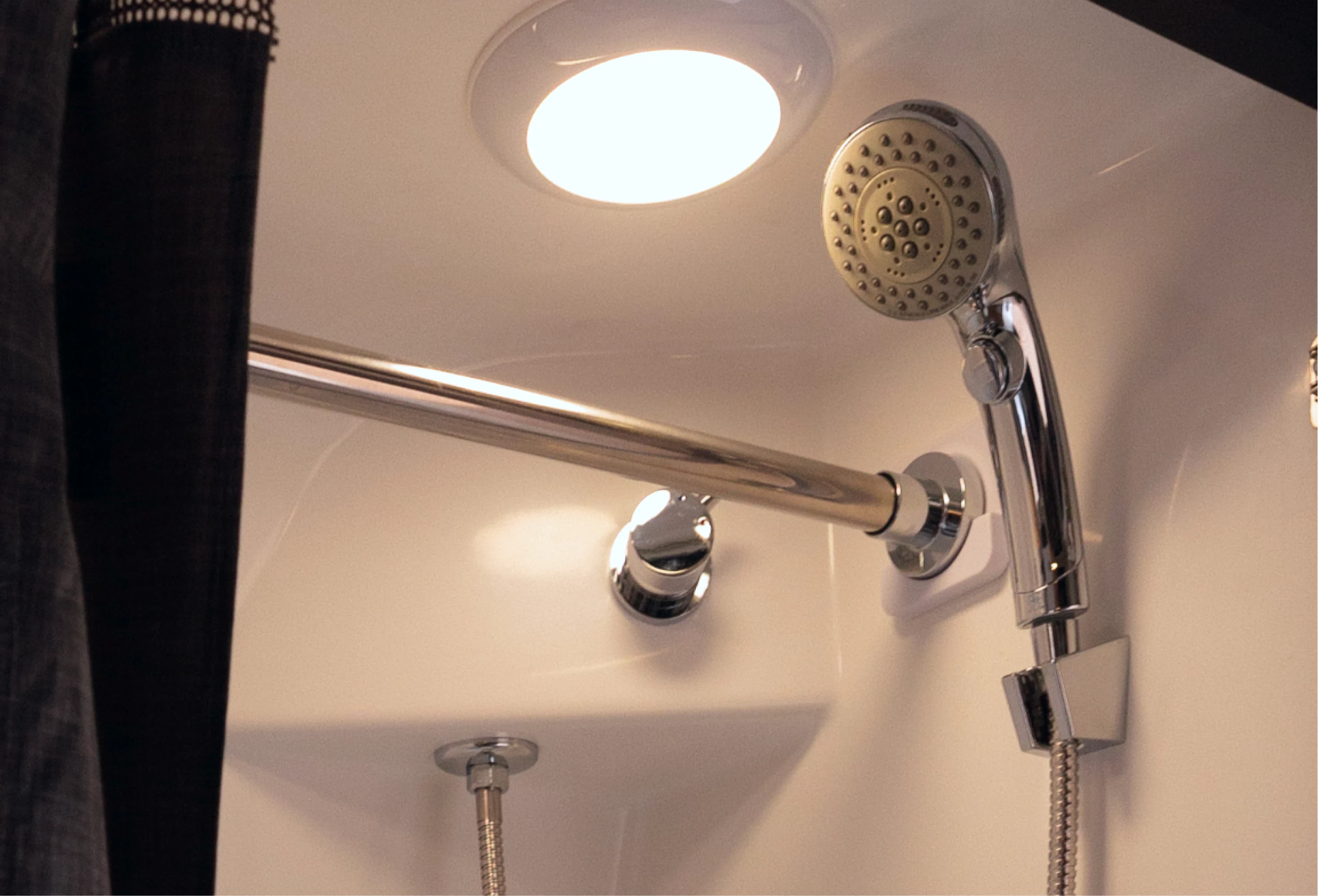 Modern showerhead and curtain in camper van adventure rig bathroom