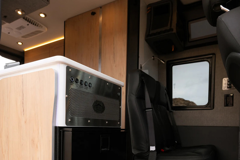 Modern Beast MODE van interior with modular seating, cabinets, and control panel for camper van and vanlife adventure travel.