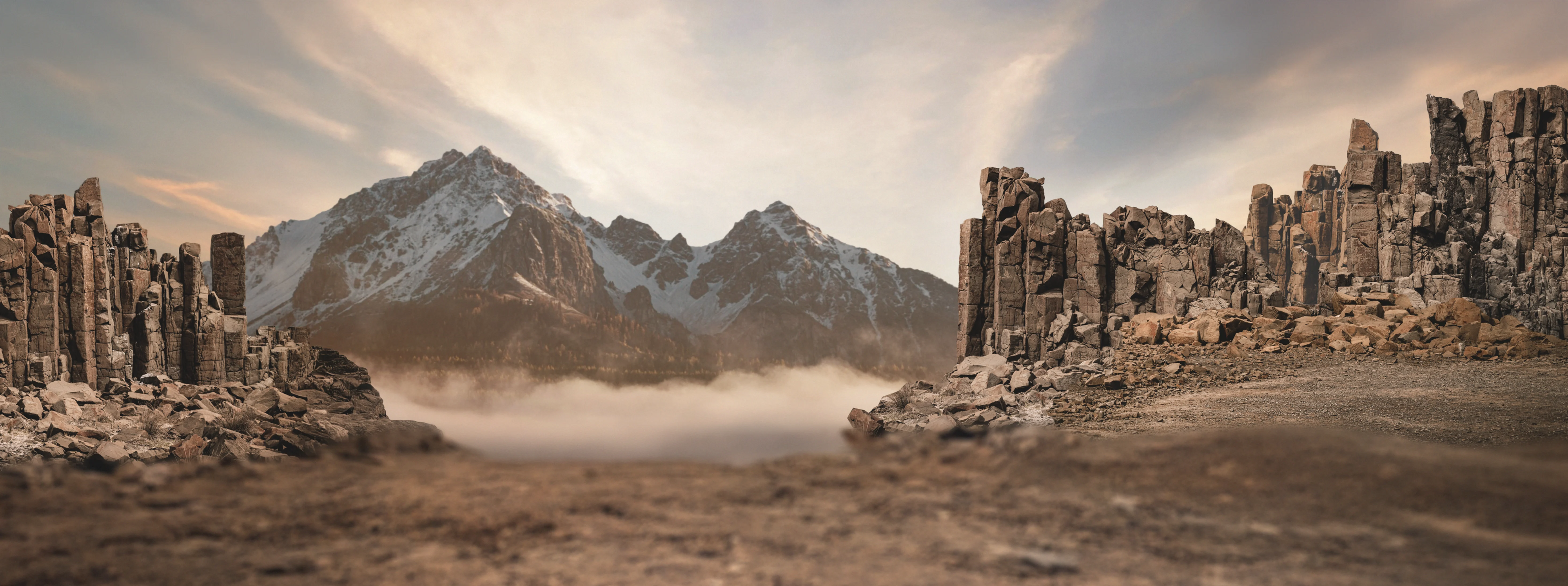Rocky overland terrain with stone pillars and snow-capped mountains, ideal for camper van adventure travel, overlanding, and vanlife experiences.