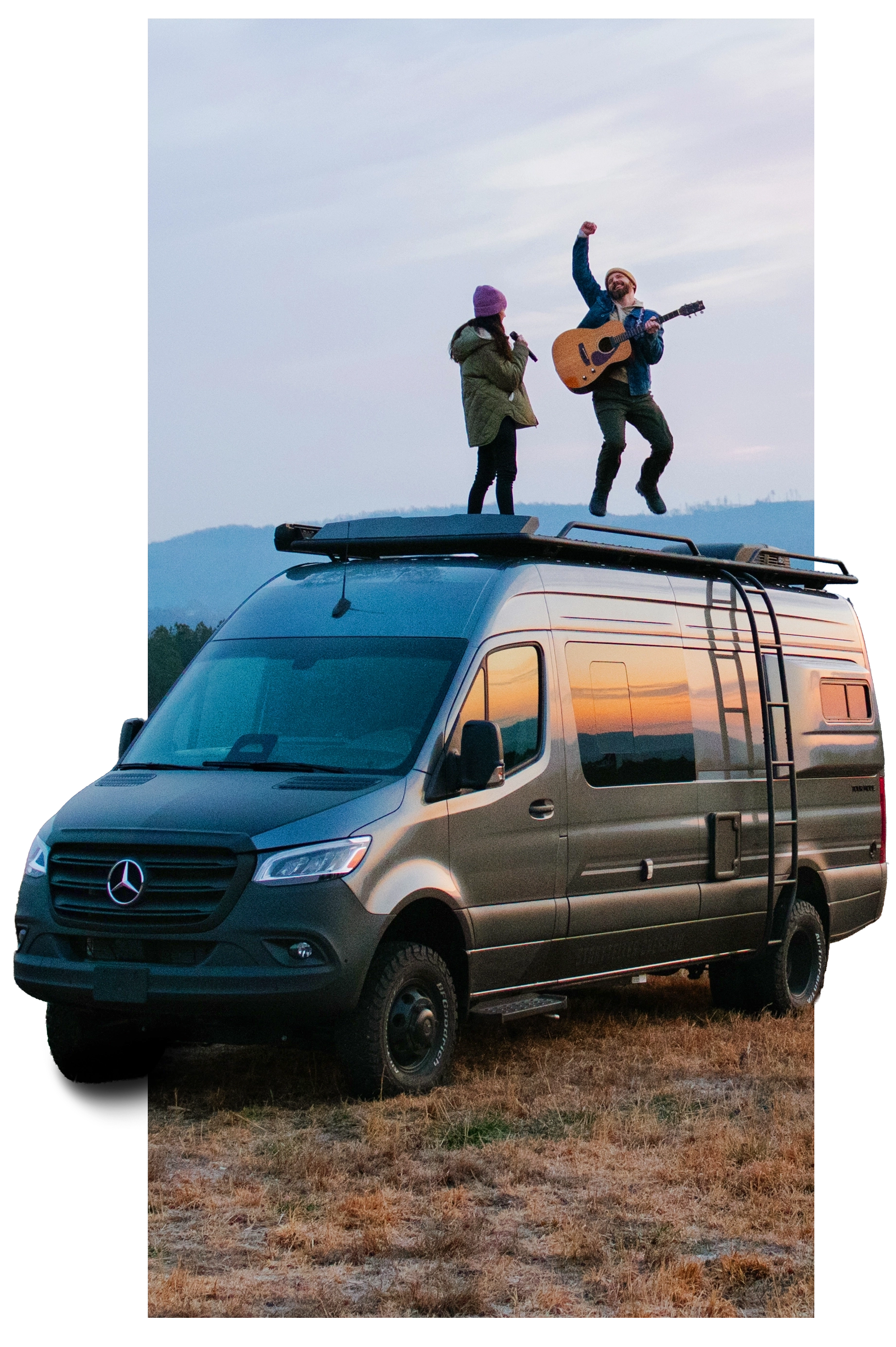 Two people on top of a van with mountains in the background. Storyteller Overland, Camper Van, Campervan, Adventure Van, Class B RV, Small Motorhome, Overland, Overlanding, Offroad Vehicle, Vanlife, Van life, TOUR MODE