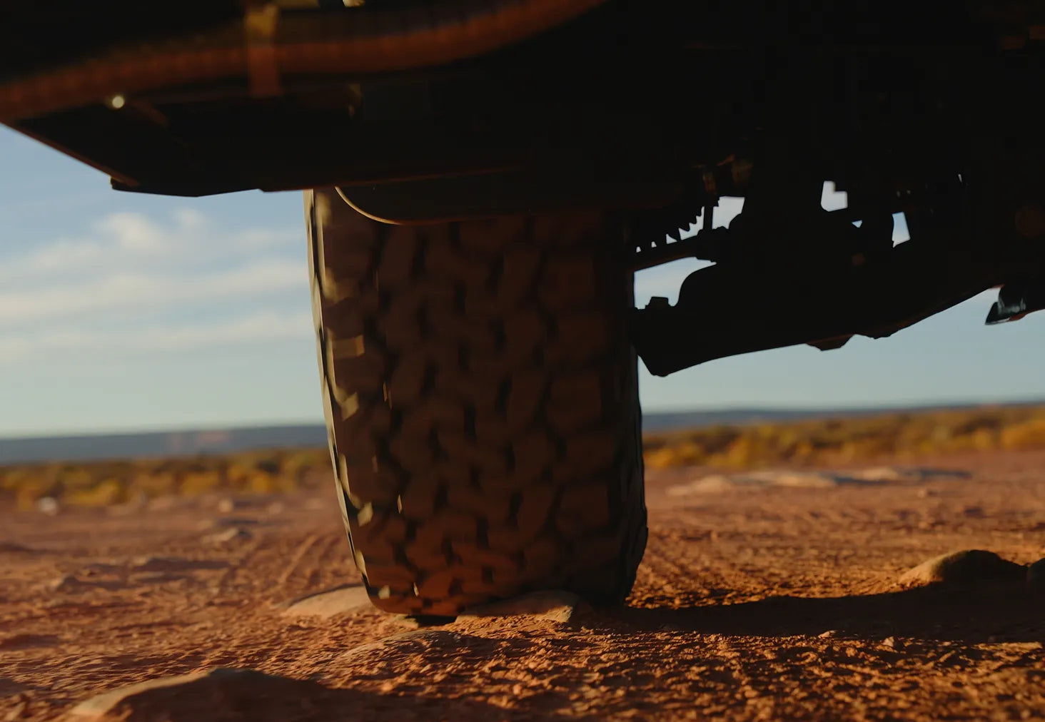 All-terrain tire of an Adventure Van or Class B RV driving on rugged offroad terrain