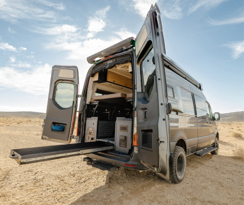 Offroad Sprinter 4x4 camper van with open rear doors, custom storage, and adventure van interior