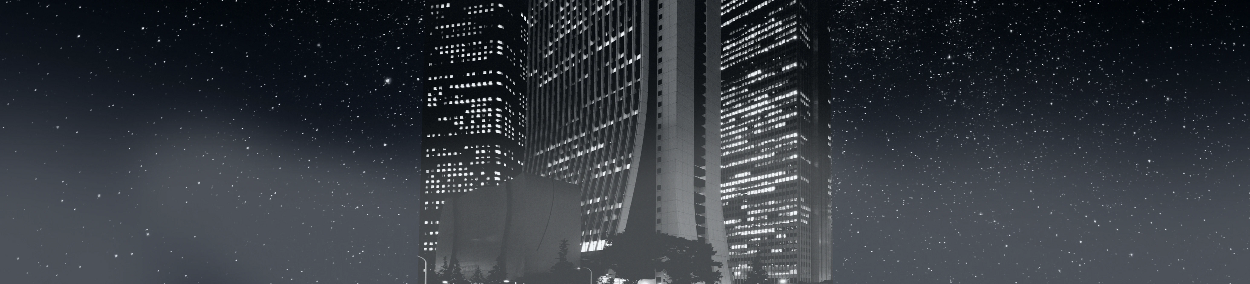 Night cityscape with tall buildings illuminated, under starry sky, modern urban skyline
