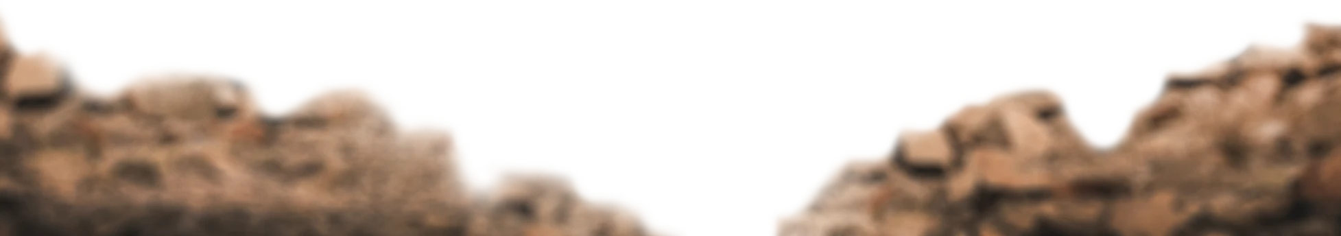 Blurry brown rocky terrain, evocative of rugged overland or offroad adventure settings